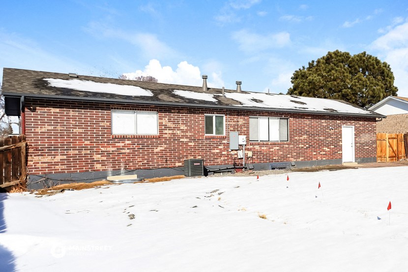 a brick house with snow in front of it