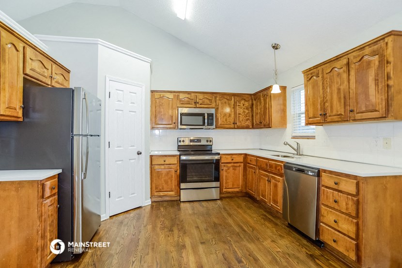 a kitchen with wooden cabinets and stainless steel appliances