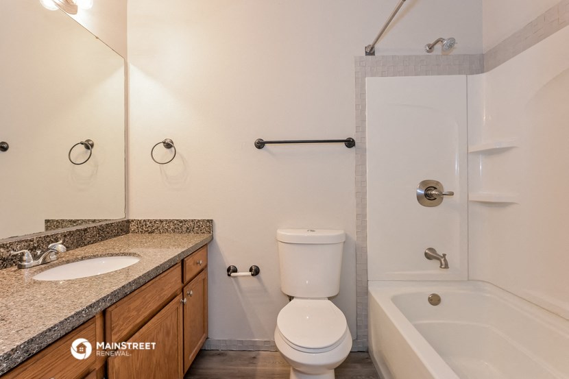 a bathroom with a sink toilet and shower and a bath tub