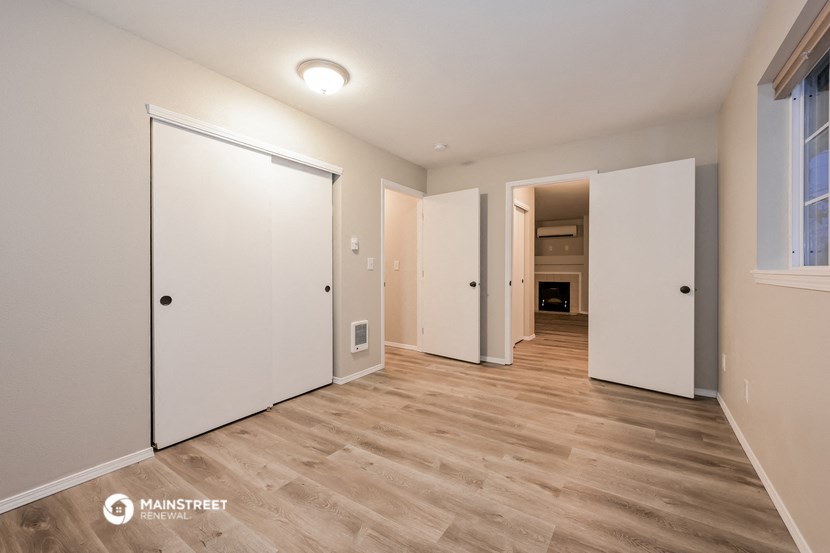 a bedroom with two closets and a door to a hallway