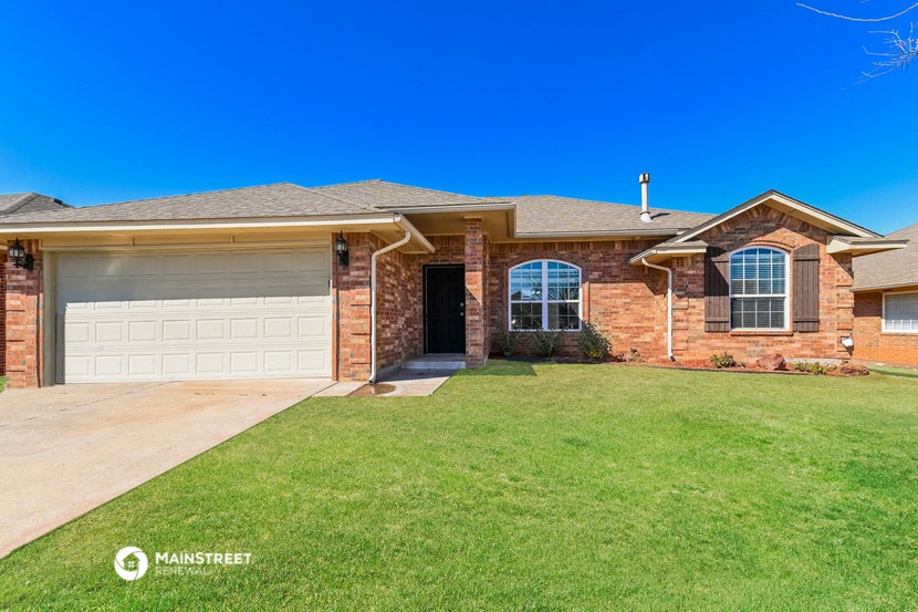 a house with a lawn and a garage door