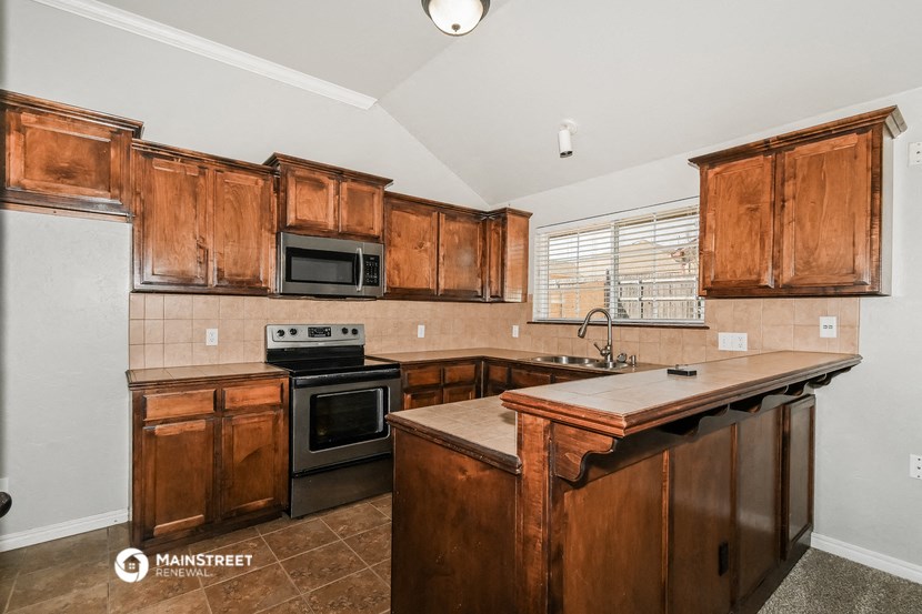 a kitchen with wooden cabinets and a counter top