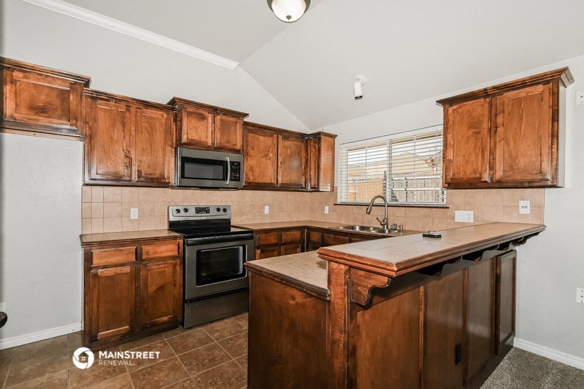 a kitchen with wooden cabinets and a counter top