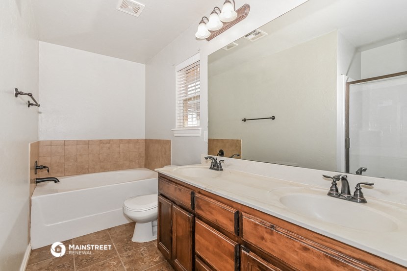 a bathroom with a sink and a tub and a toilet