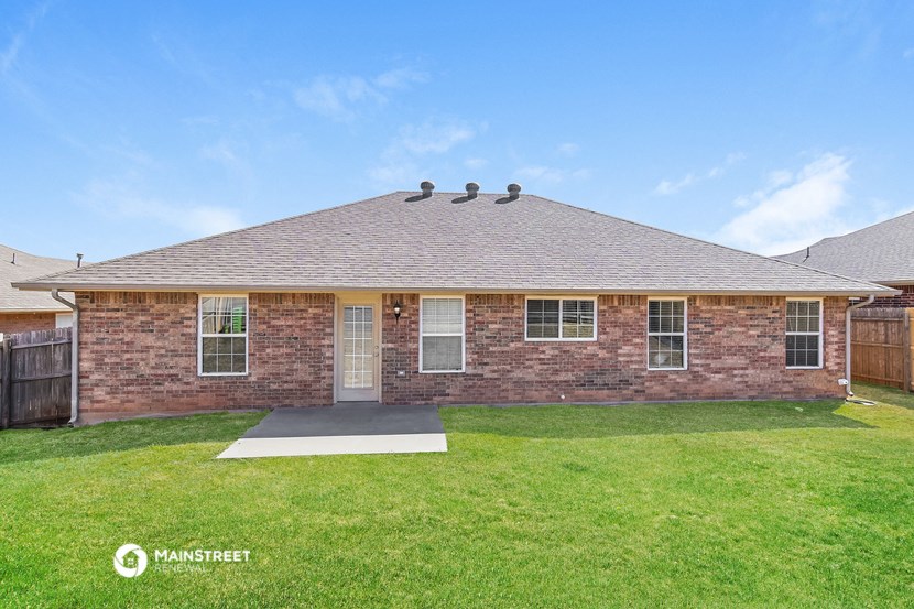 a brick house with a yard and grass