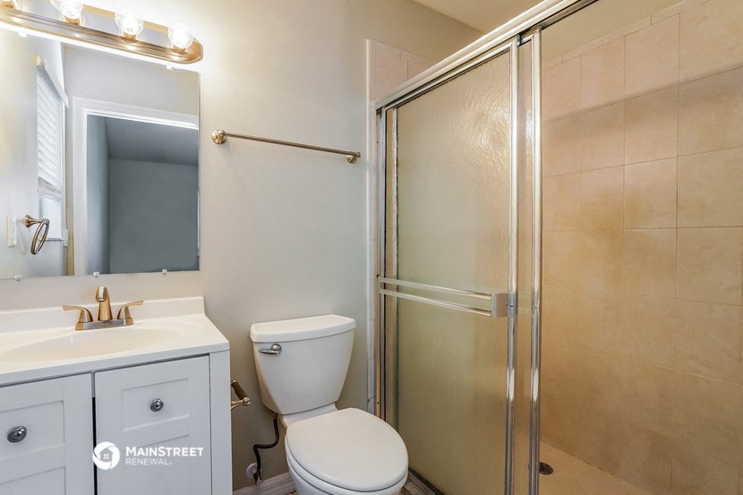 a bathroom with a shower and a sink and a toilet