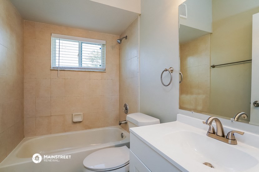 a bathroom with a tub and a sink and a toilet