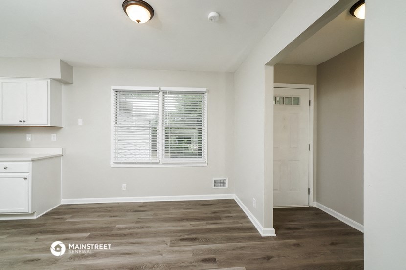the kitchen and living room of a renovated house