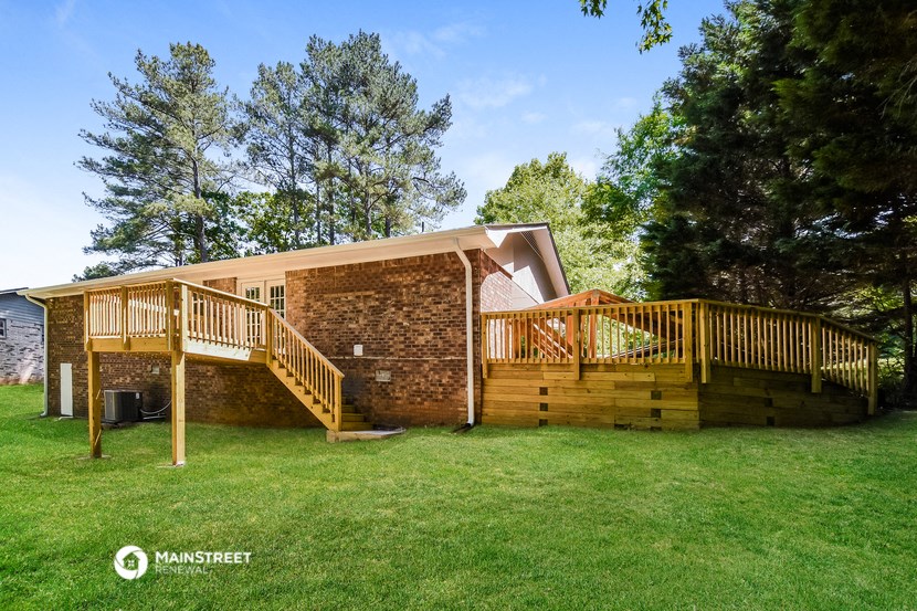a house with a deck and a ramp to the side of it