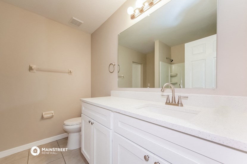 a bathroom with a sink and a mirror and a toilet