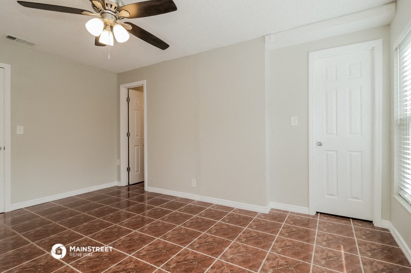 the living room of a home with a ceiling fan