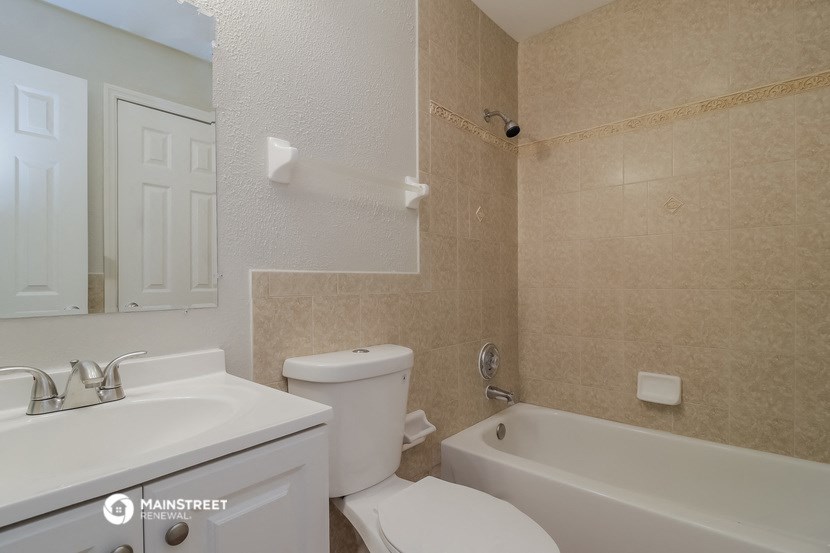 a bathroom with a toilet and a tub and a sink