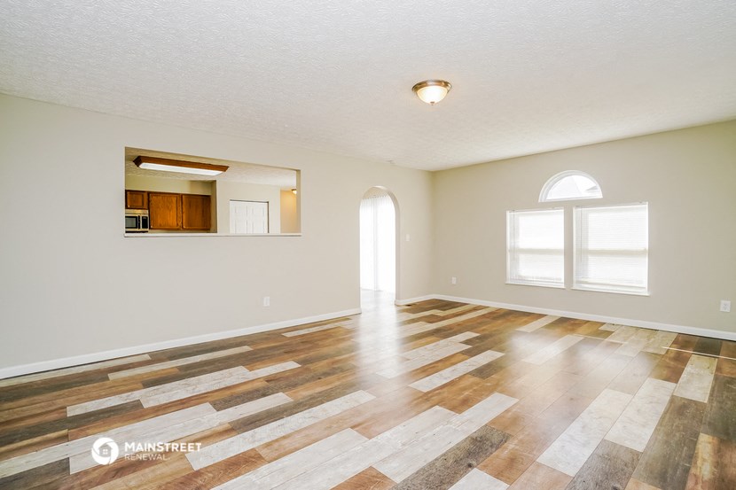 the living room and dining room with hardwood flooring