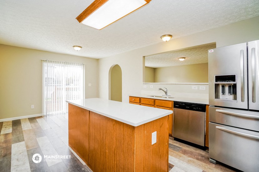 a kitchen with stainless steel appliances and a white counter top