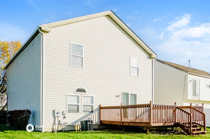 a white house with a deck in front of it