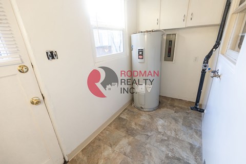 A room with Rodman Realty Inc. logo on the wall.