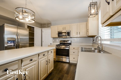 A modern kitchen with wooden cabinets and stainless steel appliances.