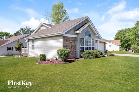 a home with a front yard and grass and a lawn