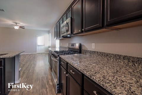 renovated kitchen with granite counter tops and stainless steel appliances at the preserve apartments