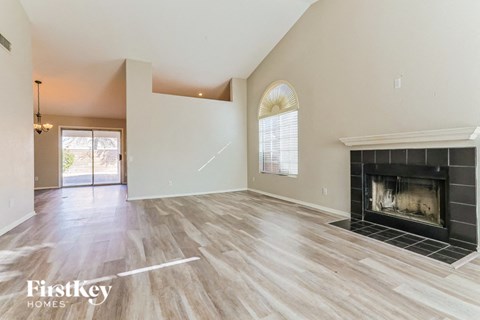 the living room has a fireplace and hardwood floors
