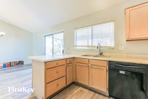 a kitchen with wooden cabinets and a sink and a dishwasher
