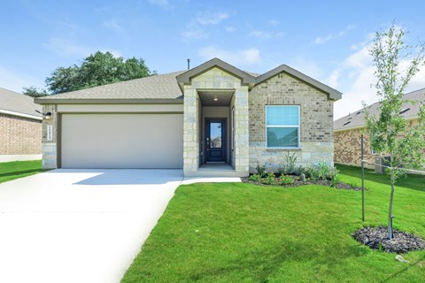 a house with a lawn and a driveway