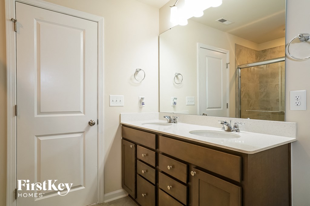 a bathroom with a sink and a mirror and a shower