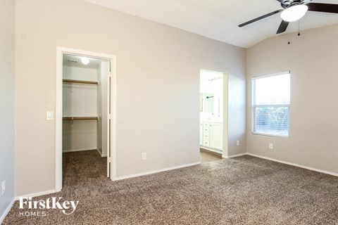 a living room with carpet and a ceiling fan
