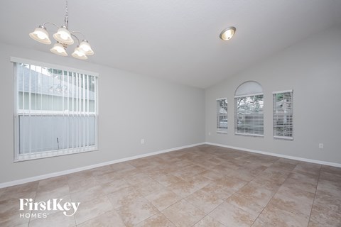 the living room is spacious and clean with a large window