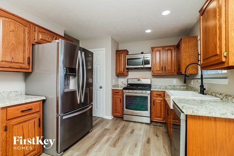 a kitchen with wooden cabinets and stainless steel appliances