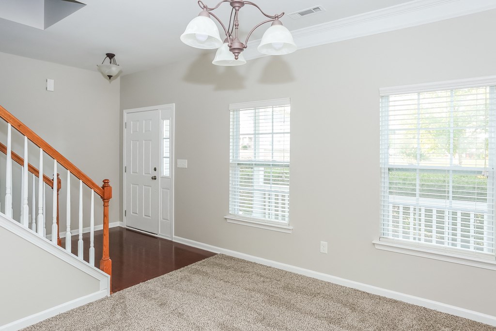 the view of the entryway of a home with windows and a door