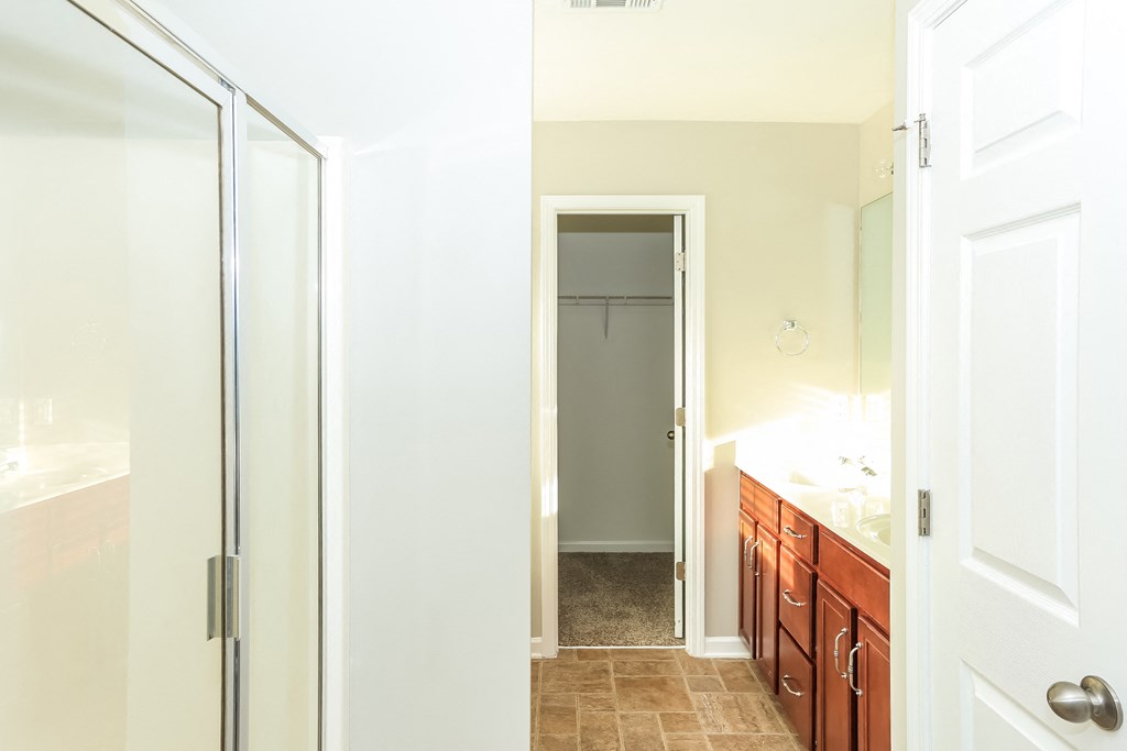 a bathroom with a shower and a sink and a mirror