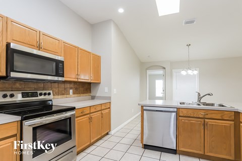 a kitchen with wooden cabinets and stainless steel appliances