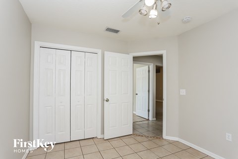 a bedroom with two closets and a door to a hallway