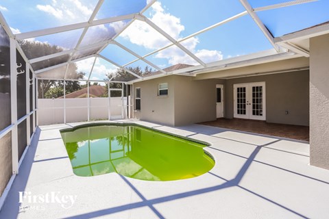 a pool in the middle of a house with a glass roof