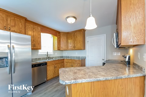a kitchen with wooden cabinets and a granite counter top