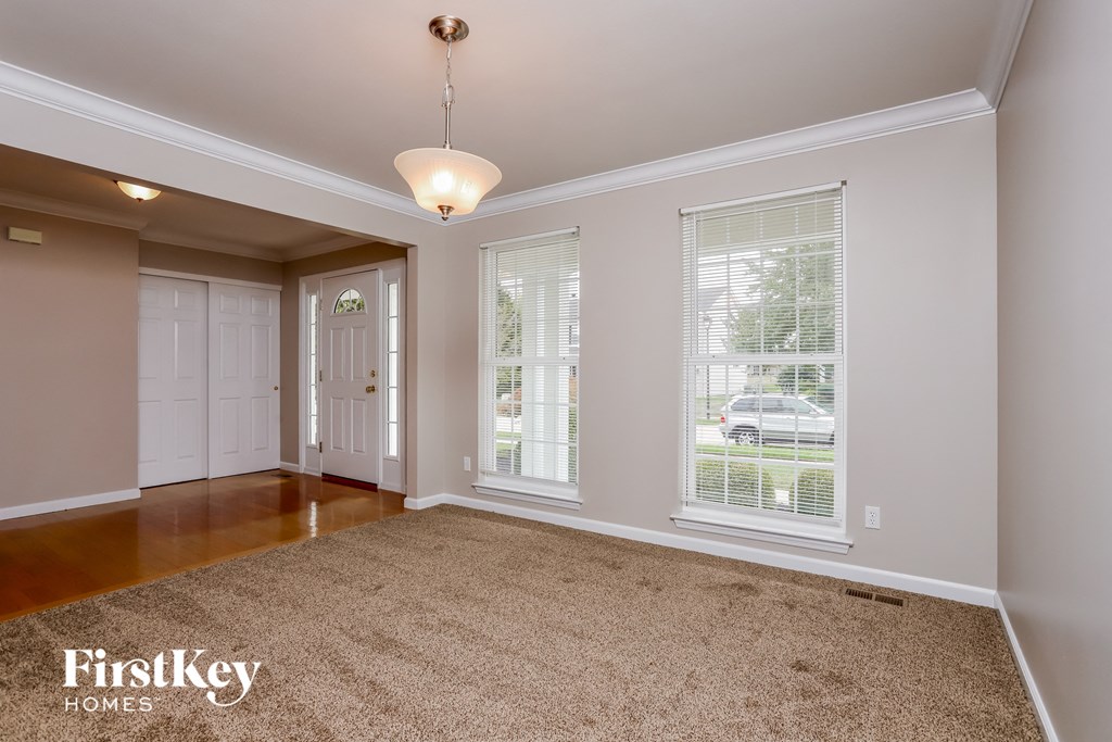 the living room and dining room of an empty house
