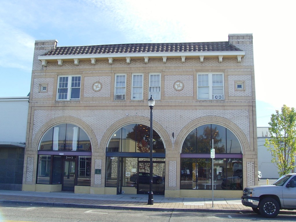 A building with a brick facade and arched windows.