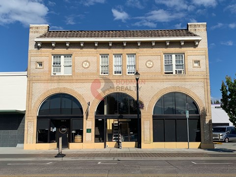 A brick building with a clock on the front.