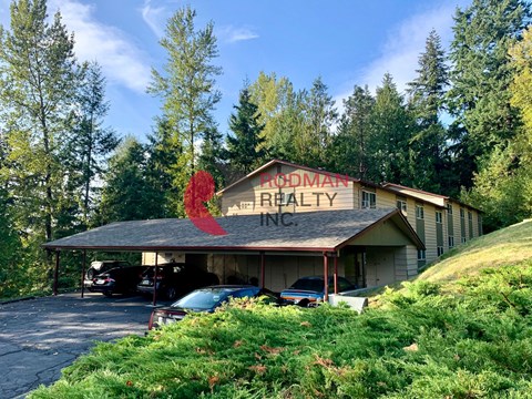 A building with a red sign that says "Brodman Ranch" is surrounded by trees.