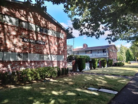 A red brick building with the words Olympic Plaza on it.