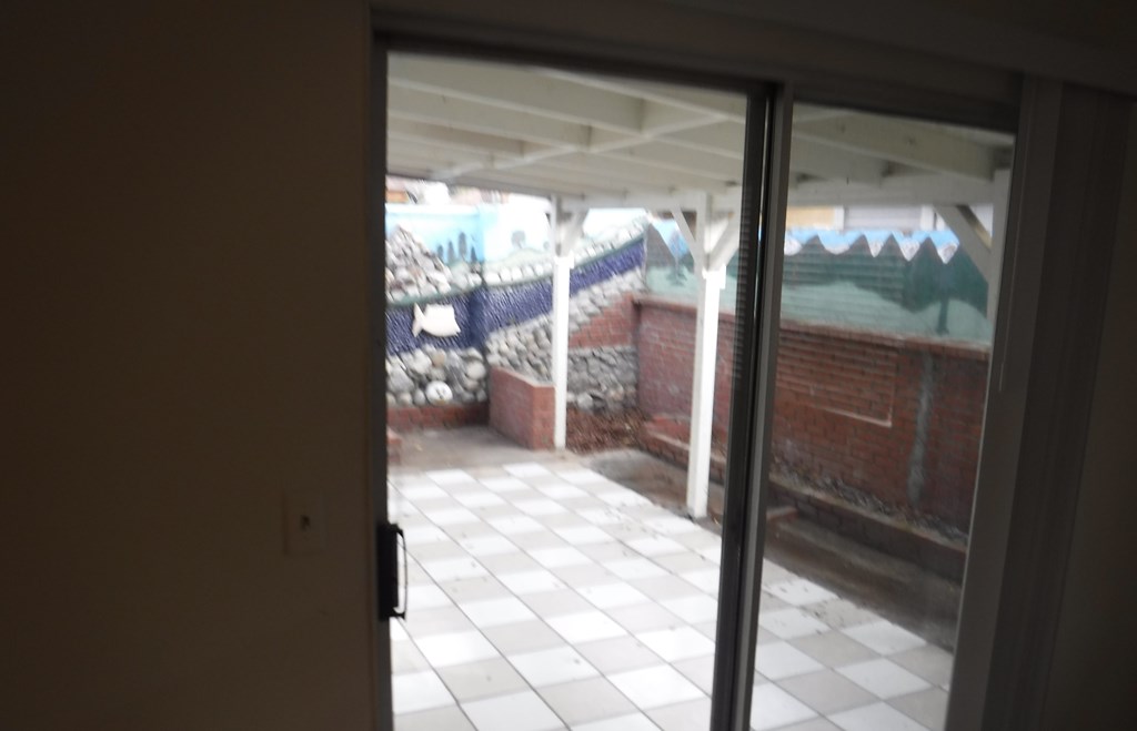 a view of the outside of a building from a door