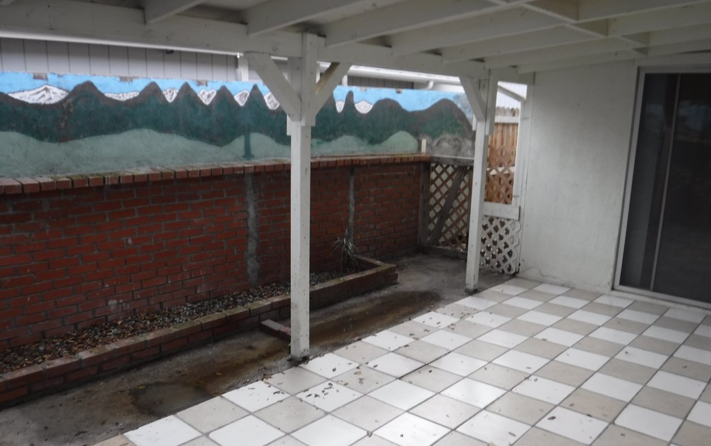 the courtyard of a building with a mural on the wall