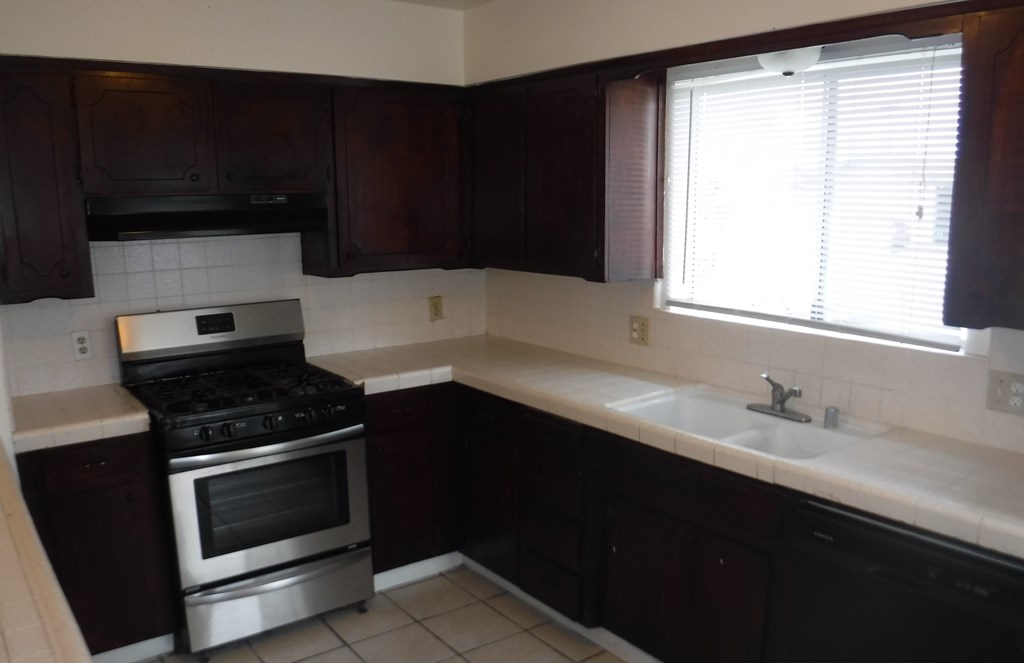 a kitchen with a sink and a stove and a window