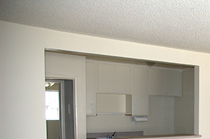 living room 644 an empty living room with a kitchen in the background
