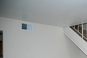 upstairs a staircase in a home with a carpeted floor