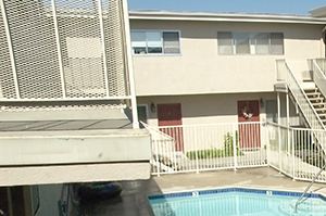 pool area an aerial view of a swimming pool and a building with a staircase