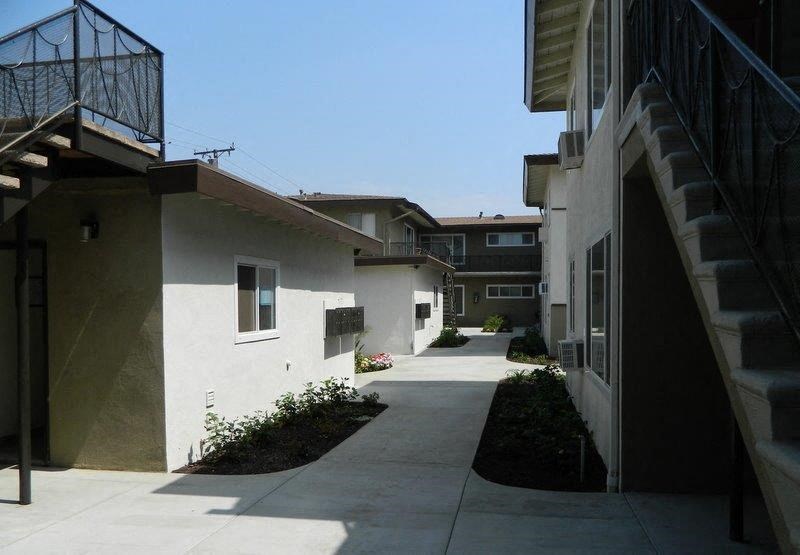 a walkway between some buildings with stairs