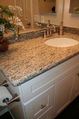 a bathroom counter with a sink and a mirror