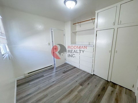 A room with Rodman Realty Inc. sign on the wall.